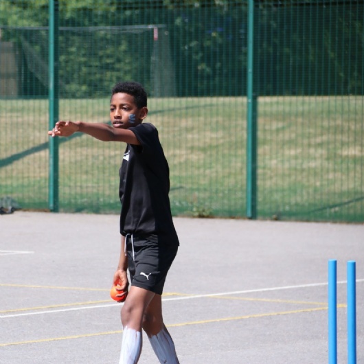 student bowling at sports day cricket